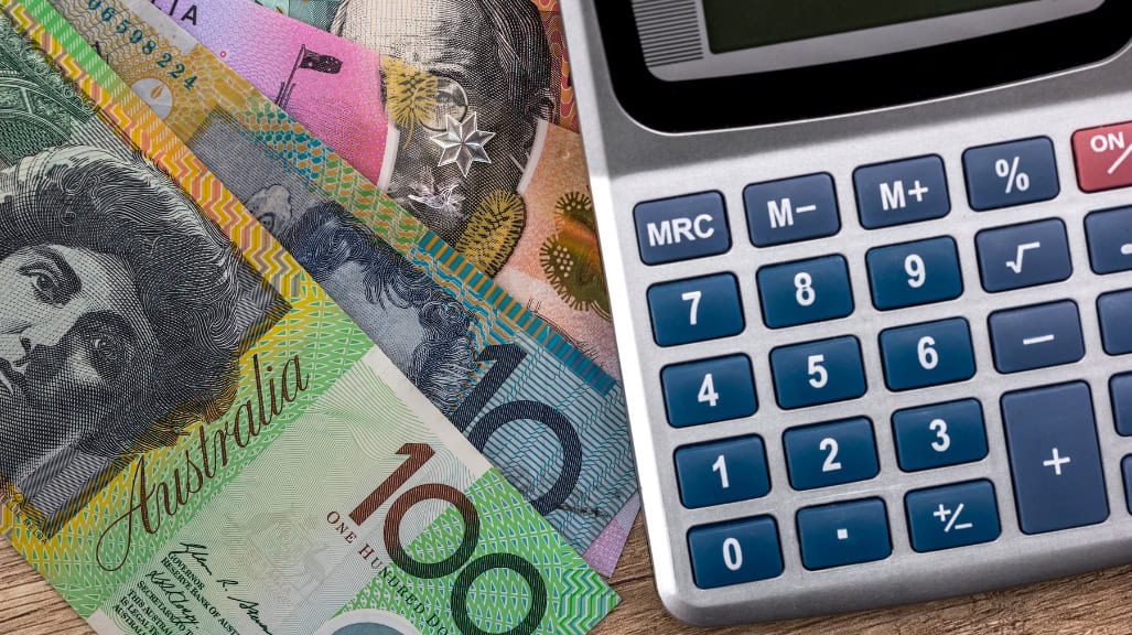 Accountant in Reservoir At Latitude Accountants. Australian currency and calculator on desk for accounting and tax preparation